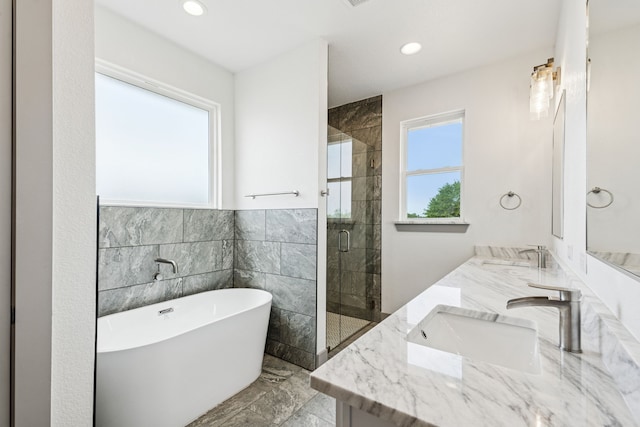 106 Maverick Way, Boyd, TX 76023 - full bathroom featuring a soaking tub, double vanity, a shower stall, marble finish floors, and recessed lighting