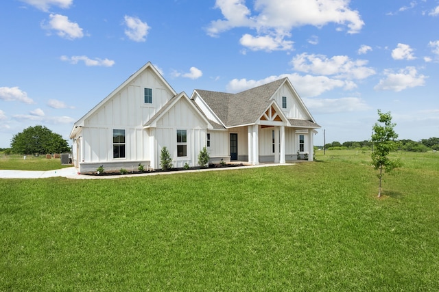 106 Maverick Way, Boyd, TX 76023 - modern inspired farmhouse featuring board and batten siding, a front yard, a porch, and central AC