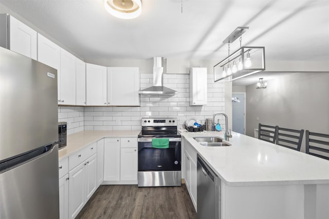 2713 Wembley Dr, Garland, TX 75041 - kitchen featuring stainless steel appliances, a sink, wall chimney exhaust hood, and decorative backsplash
