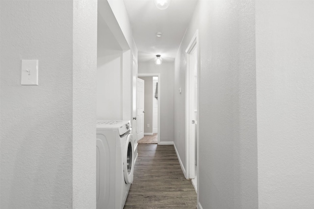 2713 Wembley Dr, Garland, TX 75041 - corridor featuring dark wood finished floors, baseboards, washer and dryer, and a textured wall