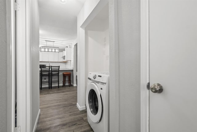 2713 Wembley Dr, Garland, TX 75041 - washroom featuring washer / clothes dryer, dark wood-type flooring, and baseboards
