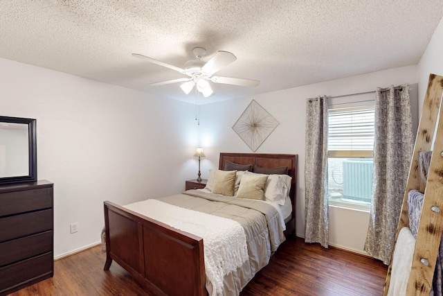 1211 Leeward Ln, Wylie, TX 75098 - bedroom featuring dark wood-style flooring, a textured ceiling, and ceiling fan