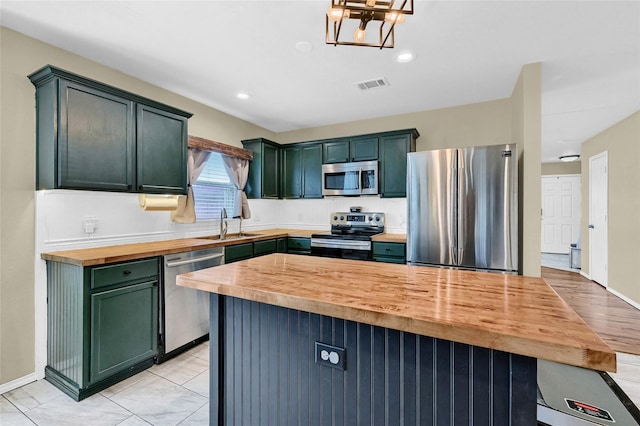 4318 Quail Run Rd, Sherman, TX 75092 - kitchen featuring stainless steel appliances, wooden counters, green cabinetry, a sink, and recessed lighting