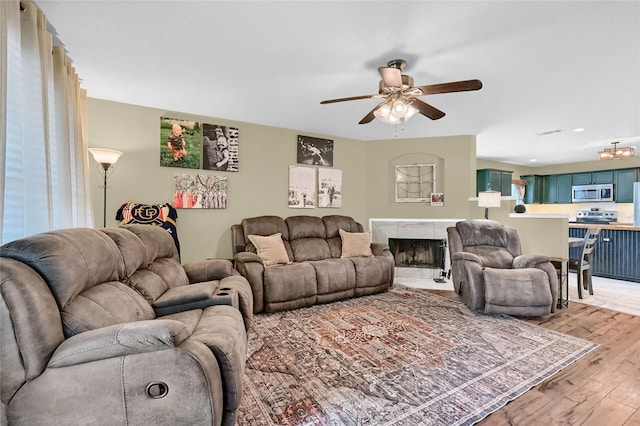 4318 Quail Run Rd, Sherman, TX 75092 - living area with a ceiling fan, light wood-style floors, and a tiled fireplace