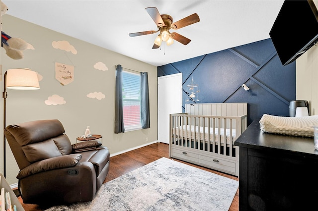 4318 Quail Run Rd, Sherman, TX 75092 - bedroom featuring wood finished floors, a crib, baseboards, and ceiling fan