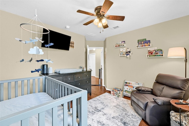 4318 Quail Run Rd, Sherman, TX 75092 - bedroom featuring wood finished floors, a ceiling fan, baseboards, and a crib