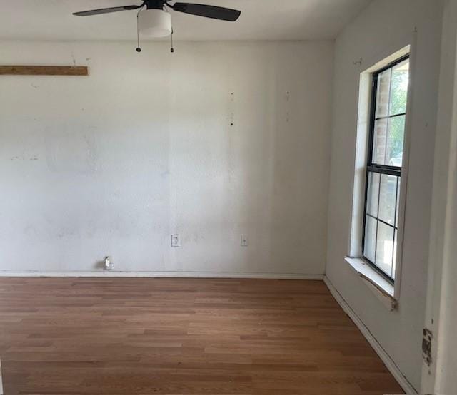 4825 Fitzhugh Ave, Fort Worth, TX 76105 - spare room featuring wood finished floors, plenty of natural light, a ceiling fan, and baseboards