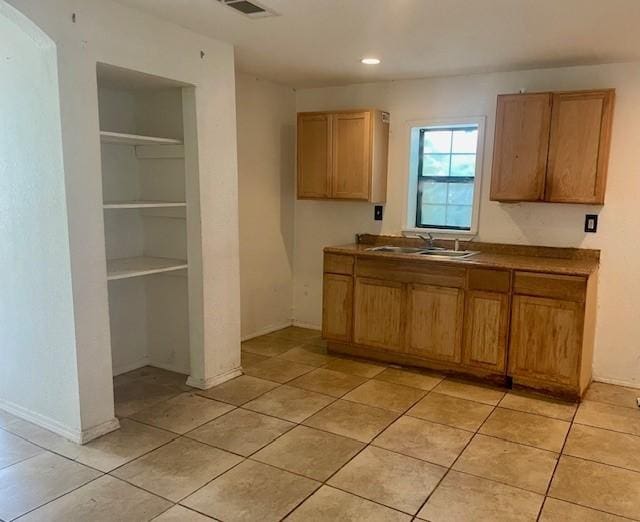 4825 Fitzhugh Ave, Fort Worth, TX 76105 - kitchen featuring a sink, light tile patterned flooring, dark countertops, and recessed lighting