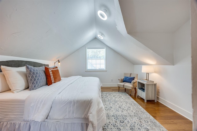 6819 Santa Fe Ave, Dallas, TX 75223 - bedroom featuring baseboards, vaulted ceiling, and wood finished floors