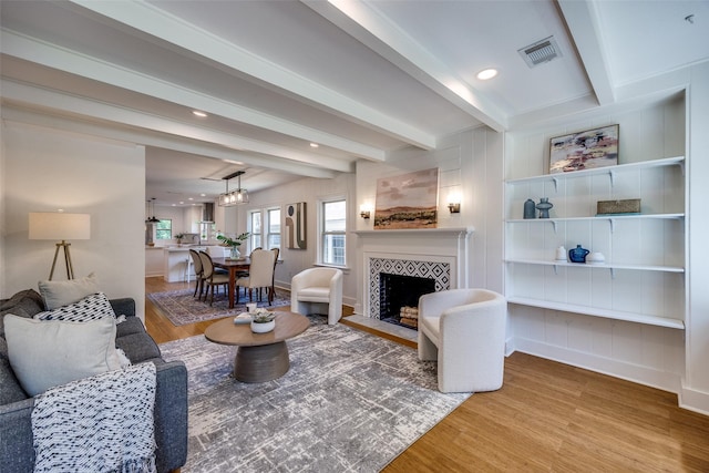 6819 Santa Fe Ave, Dallas, TX 75223 - living room featuring wood finished floors, beam ceiling, a tile fireplace, baseboards, and recessed lighting