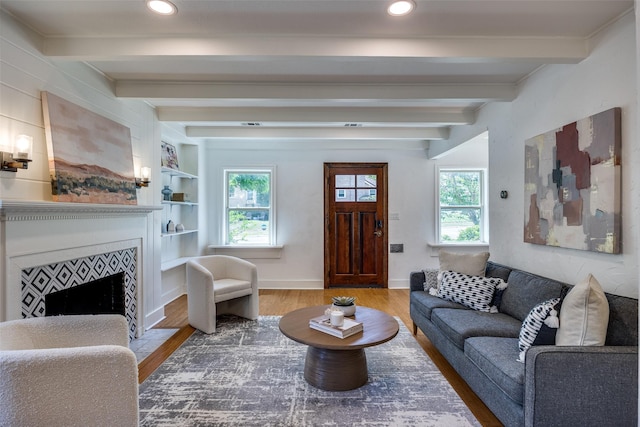 6819 Santa Fe Ave, Dallas, TX 75223 - living room with wood finished floors, healthy amount of natural light, beamed ceiling, a fireplace with flush hearth, and baseboards