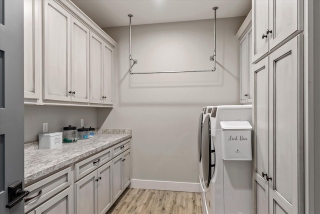 426 Vz County Road 2808, Mabank, TX 75147 - laundry area with washing machine and clothes dryer, cabinet space, light wood-type flooring, and baseboards