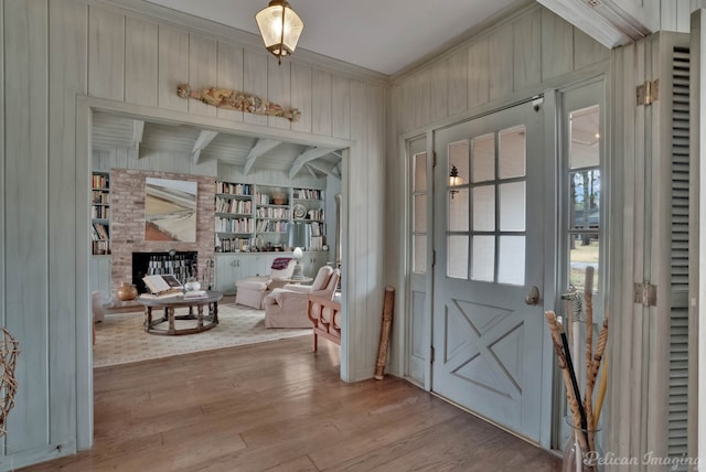 514 Pierremont Cir, Shreveport, LA 71106 - entrance foyer featuring crown molding, wood finished floors, wooden walls, and a fireplace