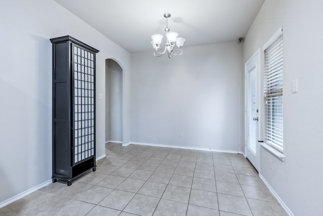 608 W Grove Cir, Anna, TX 75409 - spare room featuring arched walkways, a chandelier, plenty of natural light, and light tile patterned floors