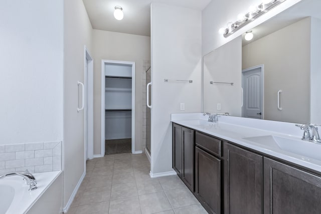 608 W Grove Cir, Anna, TX 75409 - bathroom with double vanity, a garden tub, baseboards, a spacious closet, and tile patterned floors
