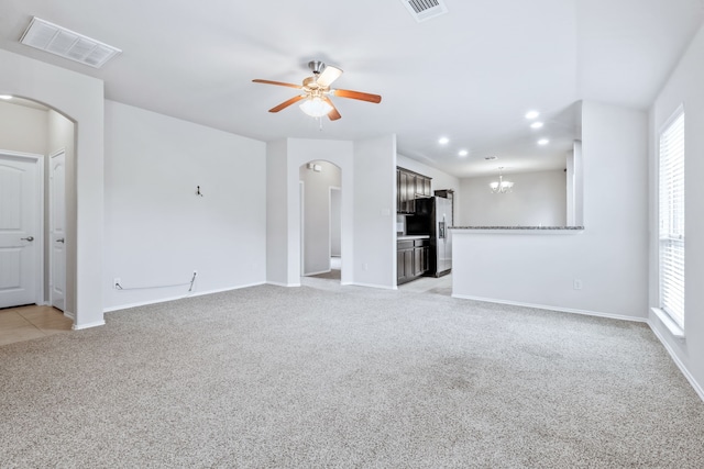608 W Grove Cir, Anna, TX 75409 - unfurnished living room featuring arched walkways, light colored carpet, a ceiling fan, baseboards, and recessed lighting