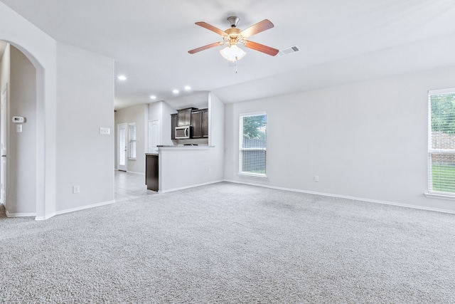 608 W Grove Cir, Anna, TX 75409 - unfurnished living room featuring a ceiling fan, light colored carpet, arched walkways, baseboards, and recessed lighting