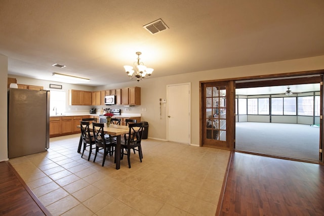 1446 Foxwood Ln, Rockwall, TX 75032 - dining room with a chandelier, baseboards, and a ceiling fan