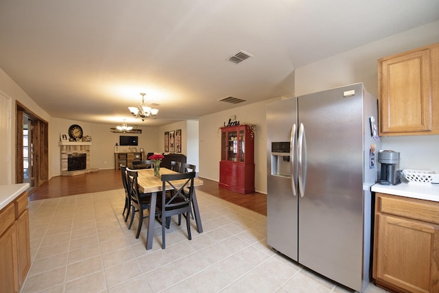 1446 Foxwood Ln, Rockwall, TX 75032 - dining area featuring a chandelier, light tile patterned floors, and a fireplace