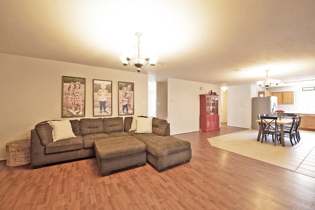 1446 Foxwood Ln, Rockwall, TX 75032 - living area with a chandelier and light wood-style flooring