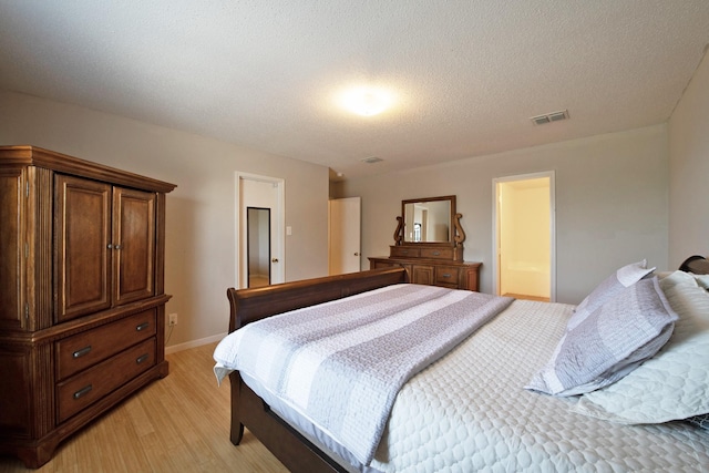 1446 Foxwood Ln, Rockwall, TX 75032 - bedroom featuring light wood-style floors, a textured ceiling, and baseboards