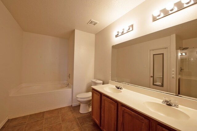 1446 Foxwood Ln, Rockwall, TX 75032 - full bath with toilet, double vanity, a stall shower, a garden tub, and a textured ceiling