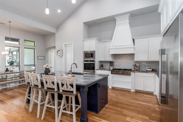 1230 Driftwood Ln, Lucas, TX 75002 - kitchen with appliances with stainless steel finishes, high vaulted ceiling, a sink, custom range hood, and dark stone counters