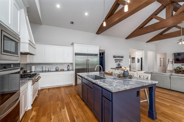 1230 Driftwood Ln, Lucas, TX 75002 - kitchen with high vaulted ceiling, a sink, open floor plan, a breakfast bar area, and white cabinets