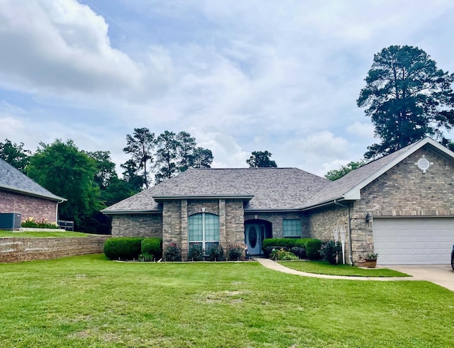 102 Dogwood Cir, Daingerfield, TX 75638 - french provincial home featuring a front yard, a garage, brick siding, concrete driveway, and a shingled roof
