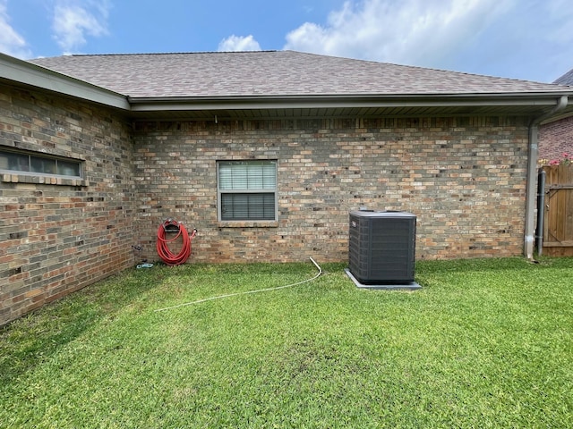 102 Dogwood Cir, Daingerfield, TX 75638 - view of property exterior featuring cooling unit, roof with shingles, and brick siding