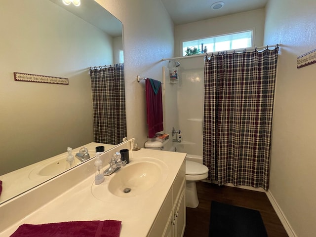 102 Dogwood Cir, Daingerfield, TX 75638 - bathroom with vanity, toilet, wood finished floors, and shower / bath combo with shower curtain