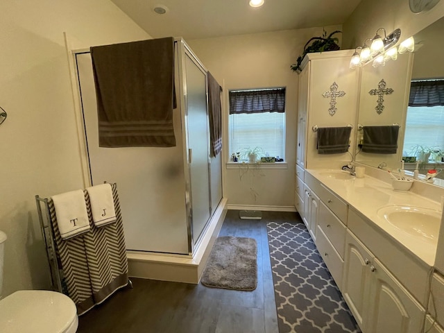 102 Dogwood Cir, Daingerfield, TX 75638 - full bathroom with double vanity, wood finished floors, a stall shower, baseboards, and toilet