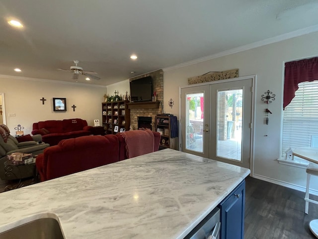 102 Dogwood Cir, Daingerfield, TX 75638 - dining room featuring dark wood-style flooring, healthy amount of natural light, ornamental molding, ceiling fan, and a fireplace