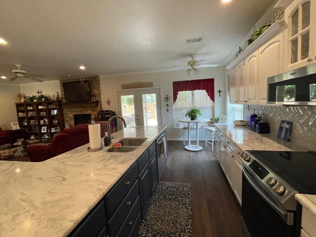 102 Dogwood Cir, Daingerfield, TX 75638 - kitchen with stainless steel appliances, a sink, ceiling fan, white cabinetry, and glass insert cabinets