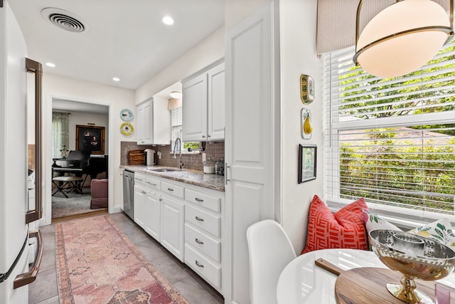 7805 Eagle Trl, Dallas, TX 75238 - kitchen featuring dishwasher, a sink, backsplash, white cabinets, and recessed lighting