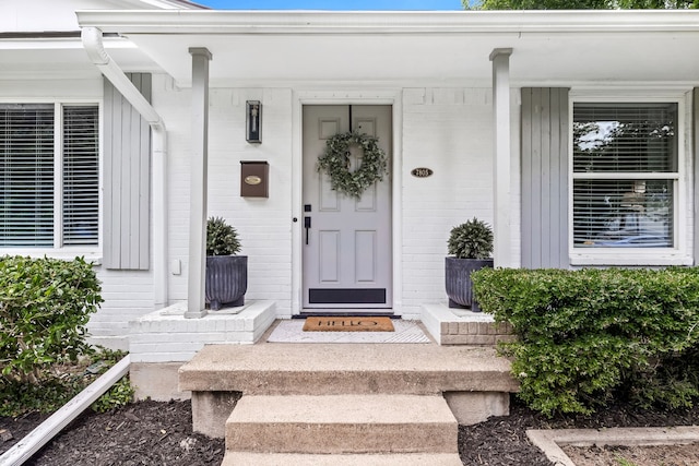 7805 Eagle Trl, Dallas, TX 75238 - view of exterior entry featuring brick siding and board and batten siding