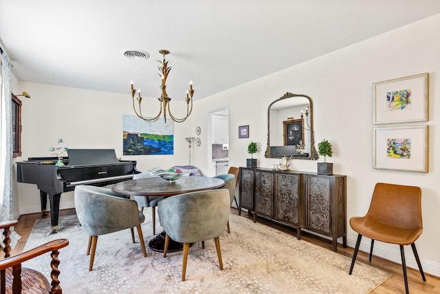 7805 Eagle Trl, Dallas, TX 75238 - dining space featuring wood finished floors, baseboards, and a chandelier