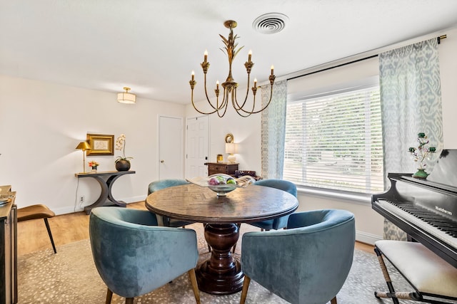 7805 Eagle Trl, Dallas, TX 75238 - dining room featuring a chandelier, wood finished floors, and baseboards