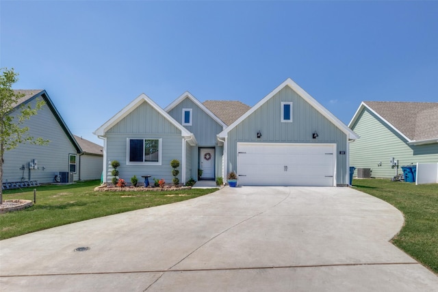 525 Brandy Ln, Tom Bean, TX 75489 - view of front facade with board and batten siding, concrete driveway, a front yard, and central AC