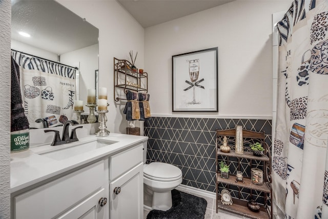 525 Brandy Ln, Tom Bean, TX 75489 - full bath with vanity, toilet, wainscoting, tile walls, and a shower with curtain