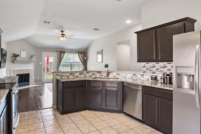1433 Wind Dancer Trl, Fort Worth, TX 76131 - kitchen featuring appliances with stainless steel finishes, ceiling fan, open floor plan, a peninsula, and tasteful backsplash