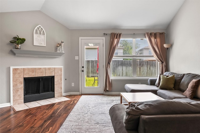 1433 Wind Dancer Trl, Fort Worth, TX 76131 - living room featuring wood finished floors, lofted ceiling, a fireplace, and baseboards