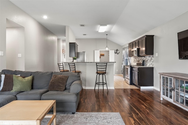 1433 Wind Dancer Trl, Fort Worth, TX 76131 - living area featuring vaulted ceiling, light wood-style floors, and baseboards
