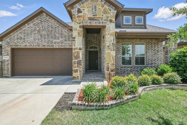 11512 Starlight Ranch Trl, Fort Worth, TX 76052 - view of front of property featuring brick siding, driveway, a garage, and stone siding