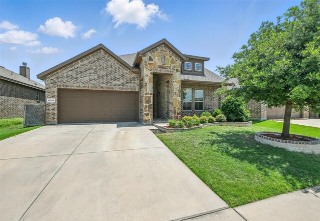 11512 Starlight Ranch Trl, Fort Worth, TX 76052 - view of front of home with brick siding, an attached garage, a front yard, driveway, and stone siding