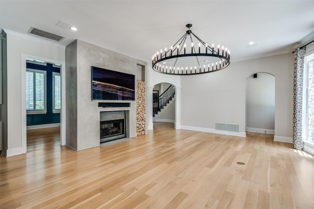 805 Cross Ln, Southlake, TX 76092 - unfurnished living room with arched walkways, a multi sided fireplace, ornamental molding, baseboards, and light wood finished floors