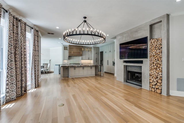 805 Cross Ln, Southlake, TX 76092 - unfurnished living room with a fireplace, light wood finished floors, a chandelier, crown molding, and recessed lighting