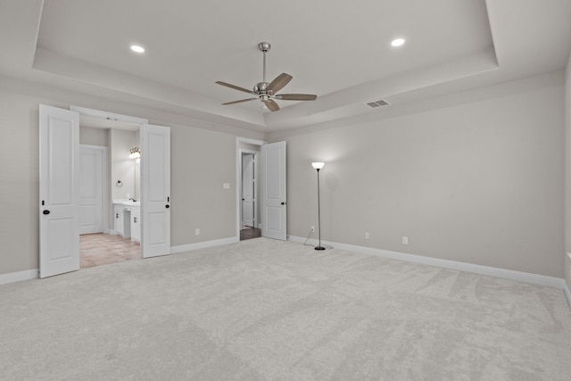 7913 Heritage Palms Trl, Mckinney, TX 75070 - unfurnished bedroom featuring a raised ceiling, light carpet, baseboards, recessed lighting, and ensuite bath