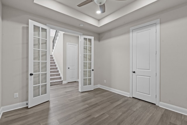 7913 Heritage Palms Trl, Mckinney, TX 75070 - unfurnished room with french doors, wood finished floors, baseboards, a raised ceiling, and recessed lighting