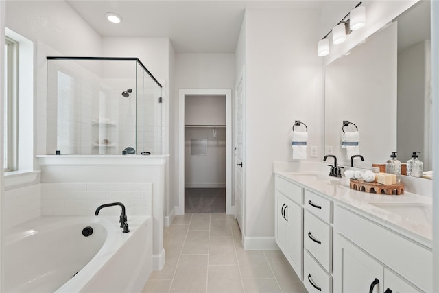 3105 Patrinia St, Royse City, TX 75189 - bathroom featuring a shower stall, double vanity, tile patterned floors, a bath, and a spacious closet